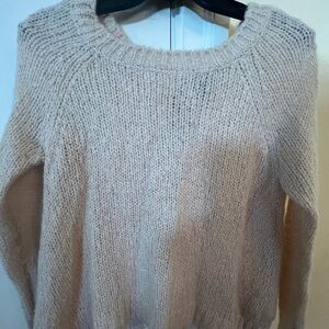 H&M sweater size XS cream color with bows on the back and openings.